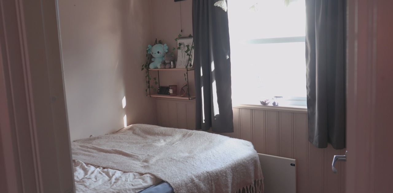 The available bedroom. Window looks out onto the houses across the street.