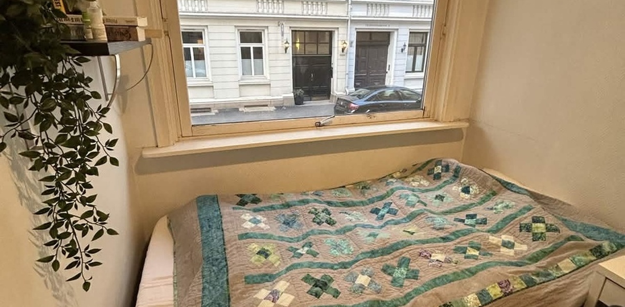 Rommet som skal leies ut. Stort vindu ut mot gaten. Inkludert rammen til senga, stort klesskap med speil og pult