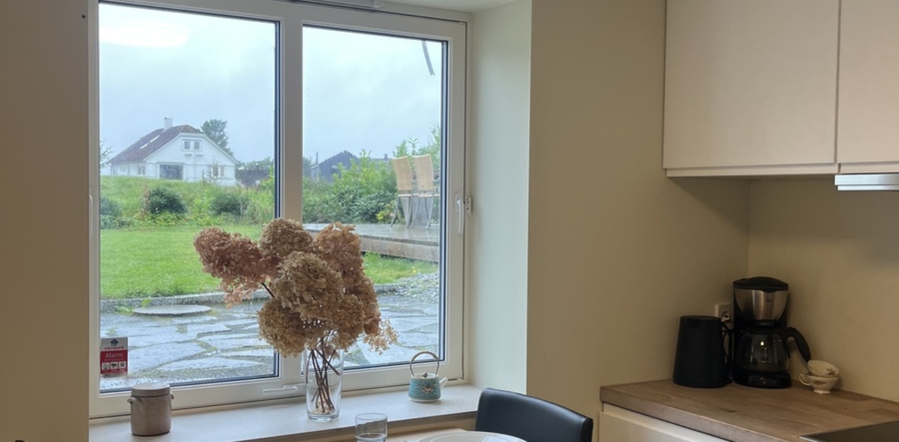 Kjøkken med spiseplass, kjøl-frys og oppvaskmaskin