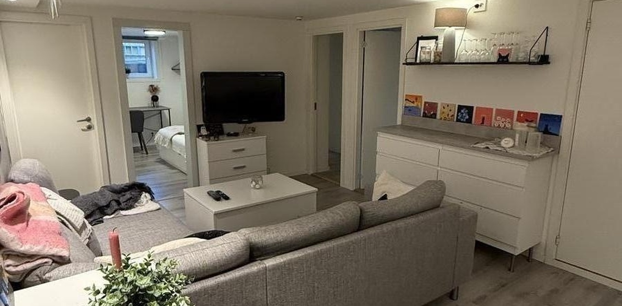 Stue. Soverom bak tv (åpen dør) skal fjernes og innlemmes som del av stuen. Veggen vil fjernes og her vil det komme spisebord og stoler.