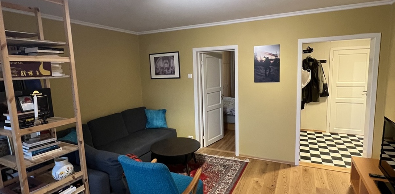 Living room with view to bedroom and hallway
